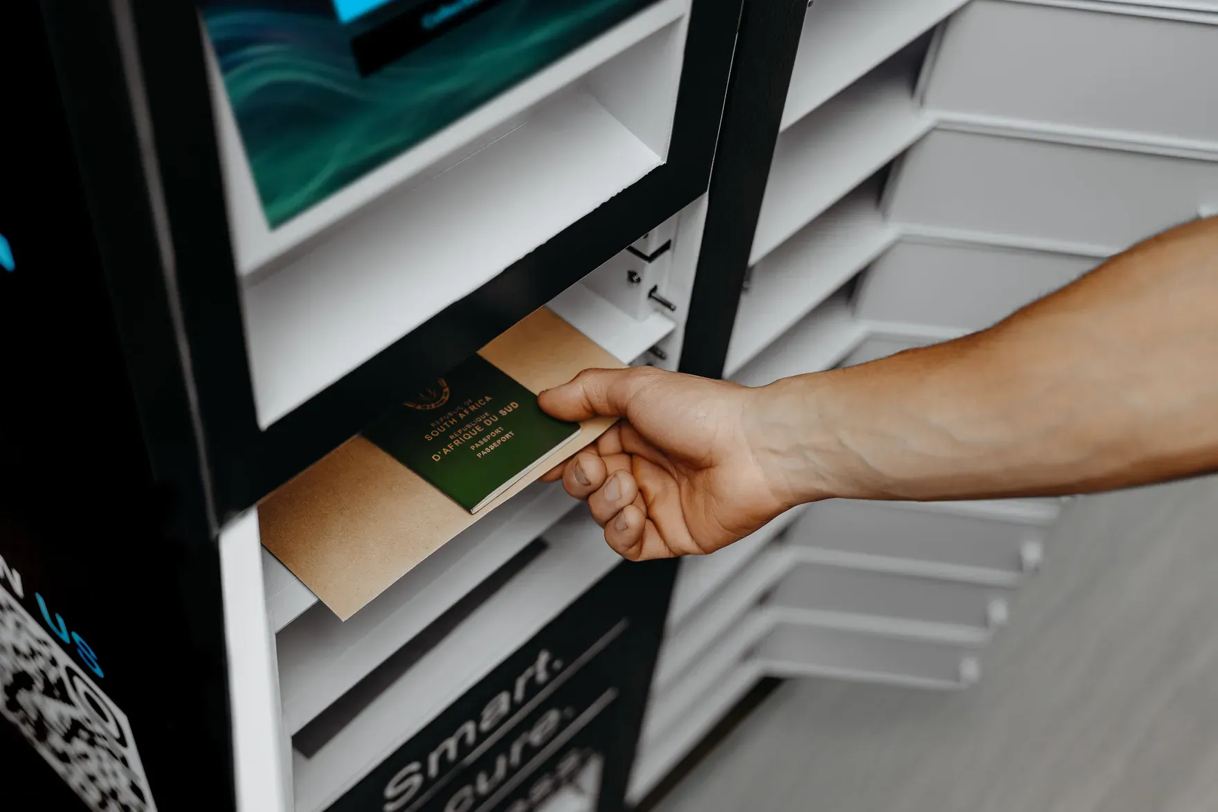 A customer reaching into an open CollectVault compartment to collect a parcel